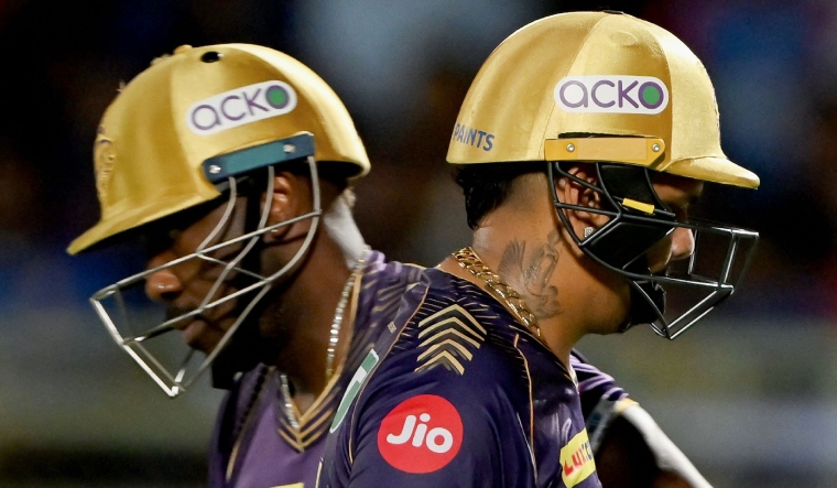 Kolkata Knight Riders Sunil Narine (R) walks back to the pavilion after his dismissal as Andre Russell enters the pitch | AFP